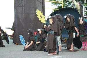 The Summer Solstice Pageant on Saturday evening of the Wooden Boat Show is one of the highlights of the weekend. Top: Last year local kids were part of a beaver brigade in the spoof about our international border blocking the arrival of the Queen of the Siscowet. Left: Will the narrator return this year as the pageant lampoons the census bureau?