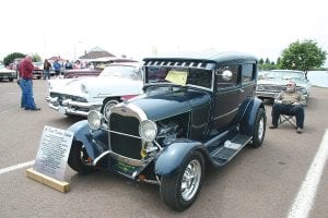 T he “People ’s Choice”        awa rd, wh ic h is selected  by v ot es of visi tors to    the Clas sic Car Show    w as th is 19 28 Ford     Tud or Seda n, owned  by M ax Hink le of Grand Marais.