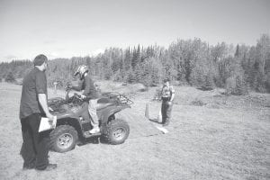 Above: Rory Bakke practices traversing—riding along the slant of a hill. Watching carefully are instructors Steve Lashinski and CO Mary Manning.