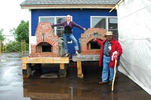 Left: Heidi Doo-Kirk and Tyler Howell were the rainsoaked auctioneers. They got some great prices on some items, but these handcrafted brick ovens did not have any takers. Perhaps the fact that they weigh two tons may have had something to do with it?