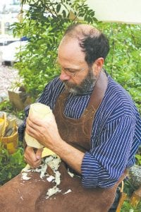 Left: Wood carver Tom Dengler quietly practiced his craft during the weekend, creating tiny vessels, utensils, book ends, vases and even a wooden replica of a Coca- Cola bottle. Dengler said he loves to carve “stuff.”