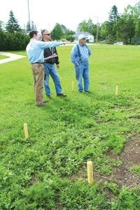 Soil & Water Conservation Technician Tristan Beaster, Soil & Water Director Jim Hall, and American Legion Post Commander Don Wilson discussed the new configuration of the rain garden on the courthouse lawn on Monday, June 21.