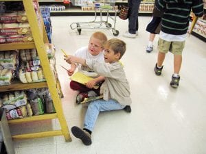 Students had a math scavenger hunt in the grocery store. Benn Rankin and Lance Bartol (front) check out the bagel prices.