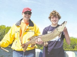 Steve and Evan Myllenbeck of Shoreview, MN, show off the nice northern caught by Steve. Evan told their guide, Joe Carlson of Joe’s Inland Fishing Guide Service, that he taught his dad to fish. Joe said he must be a good teacher, because Steve caught the biggest fish of the day, although Evan did catch some smaller walleyes.