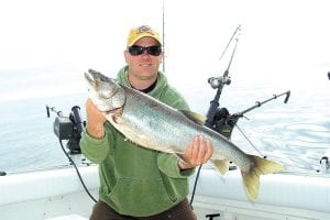 Adam Harju from Lutsen Resort shows off a beautiful 10 pound lake trout caught on the Big Lake on June 16 while fishing with Captain Darin Peck of Tofte Charters.