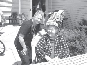 Below: Trista Fergon visits with Janet Morgan at first picnic of the season at North Shore Care Center.