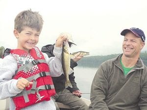 Eric, 7, shows off his first walleye. His dad, Pete, and grandpa Carl also landed some larger walleye. All of them were visiting the North Shore for a day of fishing with Joe Carlson of Joe’s Inland Fishing Guide Service.