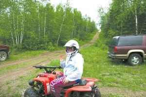 The Cook County ATV Club held its summer kick-off event on Saturday, June 12 at the Cook County RidgeRiders Snowmobile Club groomer building near Devil Track Lake. Above: Trace McQuatters, who recently completed DNR youth ATV safety training, rode the Meridian trail with friends. Right: Carter Silence, 2, enjoyed playing a carnival-like game.