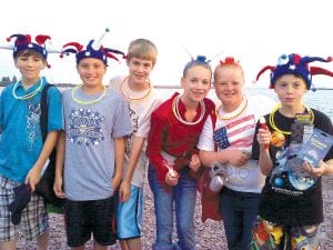 These kids were ready for the 4th of July! Members of the Mets Little League team sold glow in the dark toys as a fundraiser for Cook County Kids Plus while waiting for the fireworks show on the Grand Marais harbor. (L-R) Ben Resek, Pete Summers, Lucas Phillips, Shauna Blake, Madison Roy, and Caleb Phillips. More Independence Day fun inside on page A13.