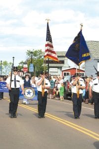 Upper left: American Legion Post 413 Color Guard, followed by the Legion Auxiliary, led the small parade through Grand Marais. The Legion and Auxiliary won the award for “Most Patriotic.” Upper right: WTIP community radio celebrated Independence Day and its 12 years on air by marching in the Tofte and Grand Marais parades. Lower left: Cook County School District 166 won the award for “Cutest Kids.”