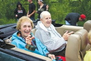 Left: Congratulations, Wehsehlers! Florence and Henry Wehseler were named the 2010 Tofte Citizens of the Year. They enjoyed their ride in a convertible in the parade despite the rain. Right: Mariam Bensaid of Orlando, Florida was an optimist about the weather—she had the face-painters make a rainbow.