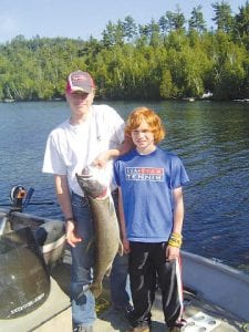 Anders Zimmer, with his brother, Damian, show off the 15.9 pound lake trout Anders caught on Clearwater Lake. The fish was 35.5 inches long.