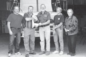 Devil Track Lake Property Owners Association (DTLPOA) president Dan Anderson donating a $1,000 check on behalf of the property owners association to Maple Hill Fire Department Chief Ed Hedstrom. Pleased to be on hand for the presentation are volunteer members Brian Olsen, Betsy Zavoral and Treasurer Eleanor Waha.