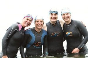 Iron women! Amber Wright, Laurie Senty and her daughters, Kelly Senty and Tess Senty at the start of the Liberty Triathlon at Lake Independence in the Twin Cities on June 12, 2010. The Sentys took part in the long course, which includes a 1.2-mile swim, a 56-mile bike ride and a 13.1-mile run. Wright, in her first marathon, participated in the Olympic distance race—a 1.5K swim, 40K bike ride and 10K run.