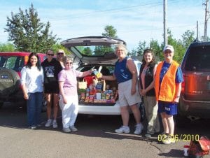 Gwen Lenz of the Cook County Food Shelf happily accepted a donation from Cook County Weight Watchers on June 2. The group donated 73.4 pounds of food, representing the weight that members had lost in the Weight Watchers “Moving More” program.