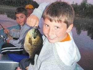 The Tim and Rhonda Lash family had great fishing this month with Little Vince’s Guide Service on the Gunflint Trail. Here Connor is holding a very nice bluegill. His brother, C.E., and dad are behind him. The whole family caught rainbow trout, splake, bluegills, walleyes, and smallmouth bass.