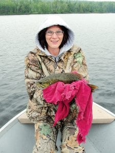 Misty Volk of Albert Lea, MN with the 18-inch bass caught on an undisclosed area lake. Although she didn’t want to touch the fish, she enjoyed the day with guide Joe Carlson of Joe’s Inland Fishing Guide Service. Joe said it rained almost the entire time on the lake but it was warm.