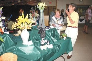 Left: Visitors to the West End Garden Club “Broadway in Bloom” flower show Saturday, July 17, 2010 at the Schroeder town hall were delighted by the creativity of arrangements that depicted Broadway shows. This year marks the club’s 75th anniversary.