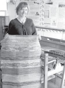 Bonner shows off her first project, a rug woven in less than five hours. For information about learning how to use the loom, contact the Historical Society at (218) 387-2883 or history@ boreal.org.