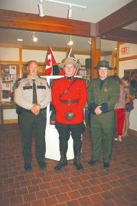 Several local law enforcement officers were on hand July 17, 2010 at the Cross River Heritage Center in Schroeder to welcome Royal Canadian Mounted Police Constable Mike Currie, who had traveled down from Thunder Bay. L-R: Cook County Sheriff Mark Falk, Constable Mike Currie from Thunder Bay, and Border Patrol Agent Aaron Logan. Currie was there with Tweed Museum Curator Peter Spooner, who gave a talk on the history of Potlatch Corporation’s ad campaign that featured the Royal Canadian Mounted Police, Canada’s federal law enforcement agency. This summer, Cross River Heritage Center has an exhibit of Arnold Friberg Mountie paintings commissioned by Potlatch.