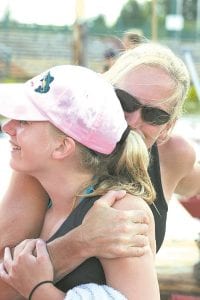 Left: Julie Collman gives her daughter a big hug after Jessica won first place in her age group. Jessica’s win was all the sweeter because it came on her birthday. Jessica is one of the top young logrollers in the country.