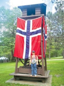 Jack Peck, 9, in front of the huge Norwegian flag at Skogfjorden, the Norwegian Language Village in Bemidji, MN. Jack spent a week at the language immersion camp.