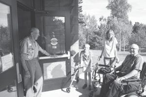 Lion Walt Mianowski greets Sam Kern, Nicki Boostrom and Gene Glader at the entrance of the Arrowhead Center For the Arts (ACA). A handicap-accessible door was recently installed much to the delight of all who attend events at the ACA. Gene Glader, far right, said he was very pleased with the new door and greatly appreciates efforts by local business and governmental agencies to accommodate the handicapped and impaired.