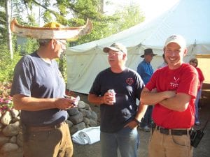 Don Kufahl (in the appropriate Birchbark canoe hat) chats with former Gunflint Trail Fire Chief Dan Baumann and Jason Merrill.