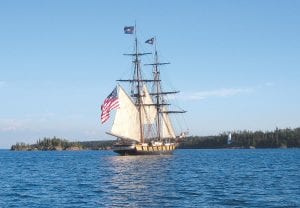 For the last week, North Shore residents have been keeping an eye out for the sight of a Tall Ship as the historic vessels traveled to Duluth for the Tall Ship Festival. Grand Portage National Monument Superintendent Tim Cochrane was visiting Isle Royale National Park and had the fortune of being in the right place at the right time. He was able to board the US Brig Niagara in Rock Harbor, which was sailing past Isle Royale from its homeport of Erie, Pennsylvania. The US Brig Niagara was built in 1988 as the official flagship of the Commonwealth of Pennsylvania. It is a reconstruction of the brig that Commodore Oliver Hazard Perry led to victory during the Battle of Lake Erie on September 10, 1813. On shore behind the Niagara is the historic Rock Harbor lighthouse, built in 1855.