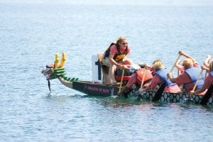 The Grand Marais harbor was filled with energy as the North Shore Dragon Boat Festival got underway on Saturday, July 31. Kelly Dupre was the drummer for the North House Folk School, encouraging her teammates to row, row, row! See more Dragon Boat action on page B1.