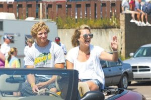 Left: 2010 Cook County exemplary students Kipp Sande (L) and Jaclyn Biesemeyer enjoy riding in a convertible in the Fisherman’s Picnic parade Sunday, August 8, 2010. Above: Senior Citizen of the Year Alton Berglund waves to the parade crowd.