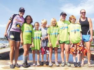 Winners and top finishers of the log rolling contest are flanked by eight-time log rolling world champion Jenny Atkinson (l) and Julie Collman (r). Kids from l-r are: Wellesley Howard- Larsen, Lucy Shaw, Jack Hoppe, Tarin Hanson, Julie Berg-Collman, and Damien Zimmer.