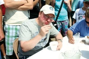 Top: Eric Humphrey of Grand Marais didn’t win the Sven & Ole’s Pizza pickled herring eating contest, but he gave it a good try and seemed to be enjoying himself. The winner was John Swanson, who has won the eating event for the last nine years! Above left: Brian Beck of Princeton won the Sven & Ole’s pizza eating contest 15 years ago. He returned to Fisherman’s Picnic to try again and gave it a valiant effort, but was beaten by Spencer Olson of Chanhassen, MN (above right).