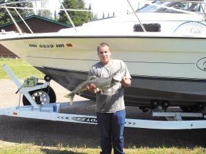 Mike LaFreniere of Grand Marais with the nice trout he caught on Lake SupeCatch rior. The trout weighed in at 11 pounds.