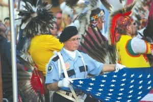 The raising and lowering of the flags is a meaningful and solemn part of the PowWow. A Boise Forte Honor Guard, a veteran, assumed the duty for the center flag.