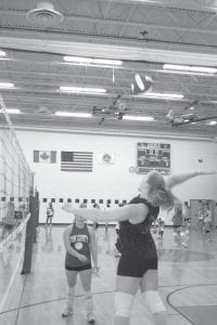 The CCHS volleyball team began serious practice last week with 33 ninth through 12th grade students reporting for practice. The Vikes hold an intersquad game on Wednesday, August 25 at 6 p.m. one hour before the football team's intersquad game. Above left: Brea Boomer (left) finishes off a spike while Kristina Rude (right) looks on. Above right: Becca Laky goes high into the air to spike the ball over the net.