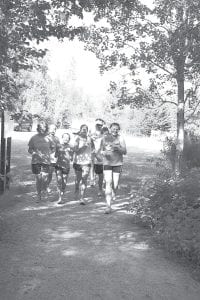 Head cross country coach Chris Hegg (in the back with cap on) said that “so far 28 girls and boys have reported for cross country practice but we expect another 10 or so to come out once school starts.” The team's first home meet is Sept. 2 at 2 p.m. on Pincushion. Hegg expects both boys' and girls' varsity teams to be very competitive this season, and a trip to state for at least several individuals if not both teams. Running in the afternoon shade is (L-R) Cheyenne Sorlie, Rose Ingebrigtsen, Matea Avado, Sarissa Falk, Chris Hegg, Audrey Summer and Baily Morrison.