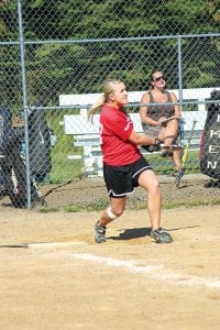 Above left: Brittany of Big Red Army prepares to run while watching if her hit will be caught or not. Above right: Carly Puch of Grand Marais played on the Pederson Disposal team, giving the ball a good whack when it was her turn at bat.