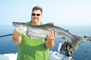 Mark Marietta from Snellville, Georgia, shows off his awesome catch. Mark caught this 38½ inch, 22.3 pound lake trout on August 22 while fishing with Captain Darren Peck of Tofte Charters. The fish was released.