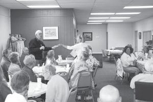 Rod Wannebo accepts a check for the Cook County Tennis Association at a celebration coffee at the Cook County Senior Center Tuesday, August 17, 2010. It was one of 35 Cook County nonprofit organizations to benefit from volunteer labor and profits this last year at First and Second Thrift Store in Grand Marais.