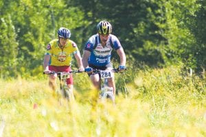 After making the 1,000-foot vertical climb, racers in the Sawtooth Challenge pedaled on through the heat on the Pincushion Mountain trails on Saturday, August 28. Derek Wallen of Apple Valley, MN (left) nears the finish line. Wallen came in second in the 16-mile race. Just ahead of him is Curtis Patak of Minneapolis, MN, who completed the 24-mile race.