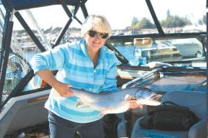 Cathi Williams of Grand Marais shows off the nice 11 pound lake trout she caught early in the morning on Wednesday, September 1, aboard the Fishin’ Chicks. The couple was “playing hooky” from their business, Beartrack Outfitters, and have a great dinner to show for it!