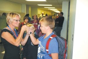 Sawtooth Elementary school teacher Jana Larson bumps fists with Jack Bilben on the first day of school. Kids seemed excited and apprehensive on their first day back from a nice long summer vacation. Out came the pencils and paper and books and crayons and calculators and away went the dog days of summer. Oh well, only eight months, three weeks left till next summer break.