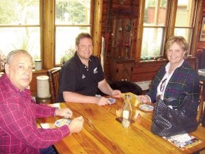 Top: The Sedlacek family said they thoroughly enjoyed “Taste of the Gunflint Trail.” Wesley Sr. said that he has visited Cook County since 1946, traveling from Downer’s Grove, Illinois. (L-R) Wesley Sr., Wesley Jr., and Roxane Sedlacek. Above left: Kristi Ostrowski sweetens up the delicious sour cream raisin pie served at Voyageur Canoe Outfitters. Above center: Donuts, anyone? Deb Smith made sure everyone got one of the Baumann family’s homemade donuts at Golden Eagle Lodge. Above right: Judy Edlund said the turnout was great at Chik-Wauk. So great, in fact, “That we ran out of blueberry pies.”