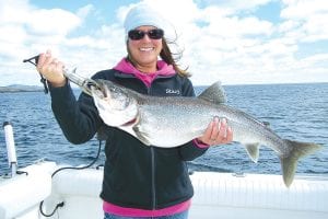 Newlywed Stacy Wagner with a beautiful catch—a 10.5-pound lake trout caught on Monday, September 13 while fishing aboard Tofte Charters with Captain Darren Peck.