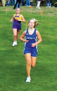 The Viking girls’ team finished third at the Invite. Upper right: Sarissa Falk kept a steady pace, finishing with a time of 22:05. Right: Shelby Ahrendt helped set the pace for the developing varsity girls’ team, finishing in 18:59.