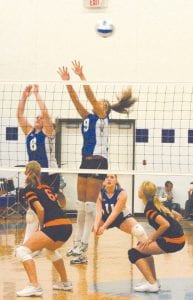 Cook County faced Wrenshall with a vengeance on Thursday, September 23, easily defeating the Wrens before an enthusiastic home crowd. Left: Viking teamwork was in evidence as Kristina Rude and Brea Boomer work together to block a Wrenshall ball, with Bekah Laky ready to back them up. Above left: Linnea Leonard rolled 10 straight service points to finish off the Wrens. Above right: Junior Sarah Fagerman hits an unstoppable spike into Wrens' territory.