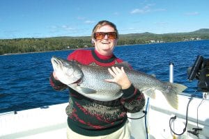 As lake trout season winds down, there are few fisherfolk finding success. Joanne Wical from Hot Springs, South Dakota caught this huge 22.5 pound 38 ½ inch lake trout on September 14, fishing with Captain Darren Peck of Tofte.