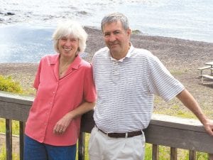 Current owners Scott Harrison and Nancy Burns take a break from resort operation for a photo overlooking the Poplar River and Lake Superior.