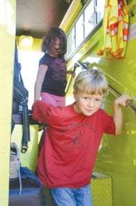 Left: Gus Hahn was all smiles as he finished his tour of the Colville fire truck. Volunteer firefighters Kim Linnell and Bob Morrisson led the kids through the tour and presented the kids with lots of information about what to do in case there is a fire.